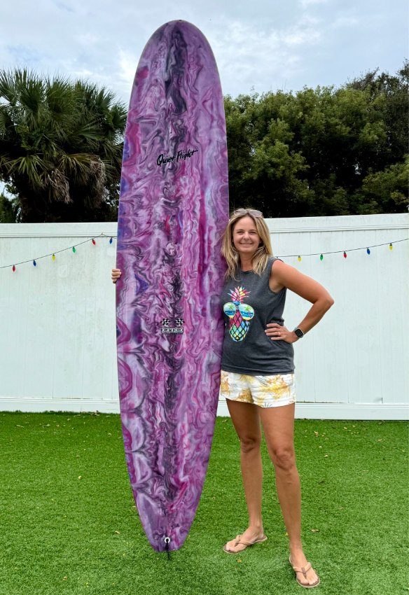 Brooke with her surfboard at home on the Atlantic Coast